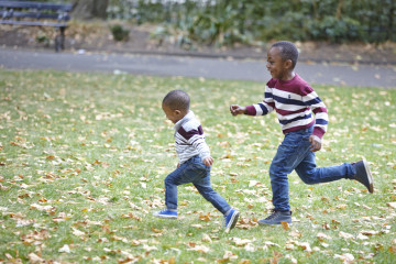 Siblings running in park