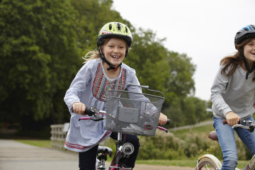 Siblings enjoy cycling in the park