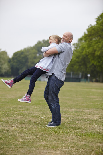 Dad and daughter having fun in park
