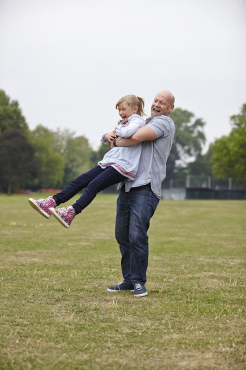 Dad and daughter playing in park