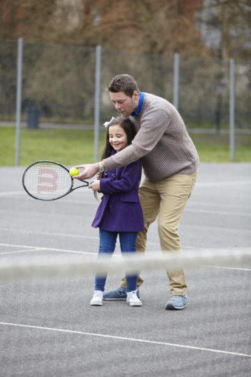 Dad coaching tennis