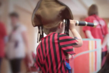 Boy dressed as pirate with telescope at Adoption Activity Day